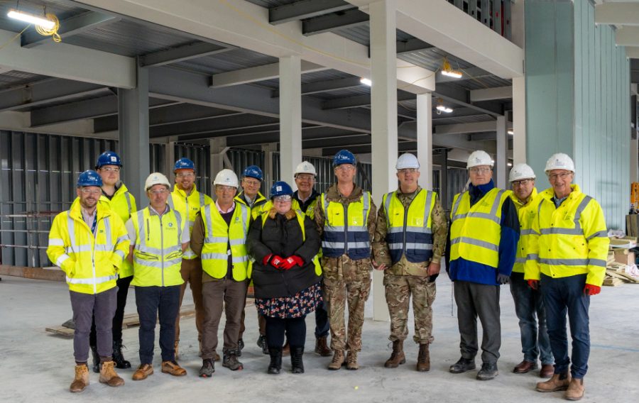 Representatives of Army Infrastructure and the Armoured Cavalry programme (centre), the DIO (right) and Aspire Defence (left), inside the Ajax facility under construction at Warminster Garrison. Copyright: Aspire Media Services.